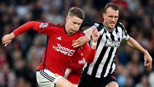 MANCHESTER, ENGLAND - MAY 15: Scott McTominay of Manchester United is challenged by Dan Burn of Newcastle United during the Premier League match between Manchester United and Newcastle United at Old Trafford on May 15, 2024 in Manchester, England. (Photo by Gareth Copley/Getty Images)