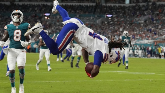 Buffalo Bills running back James Cook (4) goes airborne to score a touchdown during the first half of an NFL football game against the Miami Dolphins, Thursday, Sept. 12, 2024, in Miami Gardens, Fla. (AP Photo/Lynne Sladky)