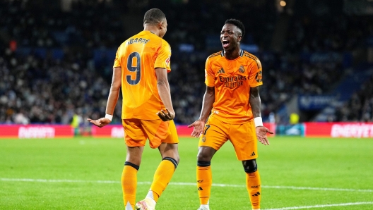 SAN SEBASTIAN, SPAIN - SEPTEMBER 14: Kylian Mbappe of Real Madrid celebrates scoring his team's second goal with teammate Vinicius Junior during the LaLiga match between Real Sociedad and Real Madrid CF  at Reale Arena on September 14, 2024 in San Sebastian, Spain. (Photo by Juan Manuel Serrano Arce/Getty Images)