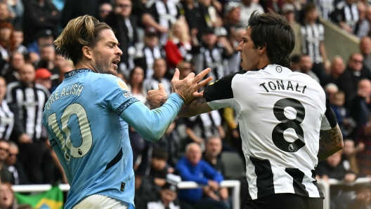 Manchester City's English midfielder #10 Jack Grealish (L) and Newcastle United's Italian midfielder #08 Sandro Tonali (R) are both booked after clashing during the English Premier League football match between Newcastle United and Manchester City at St James' Park in Newcastle-upon-Tyne, north-east England on September 28, 2024. (Photo by Oli SCARFF / AFP) / RESTRICTED TO EDITORIAL USE. No use with unauthorized audio, video, data, fixture lists, club/league logos or 'live' services. Online in-match use limited to 120 images. An additional 40 images may be used in extra time. No video emulation. Social media in-match use limited to 120 images. An additional 40 images may be used in extra time. No use in betting publications, games or single club/league/player publications. /