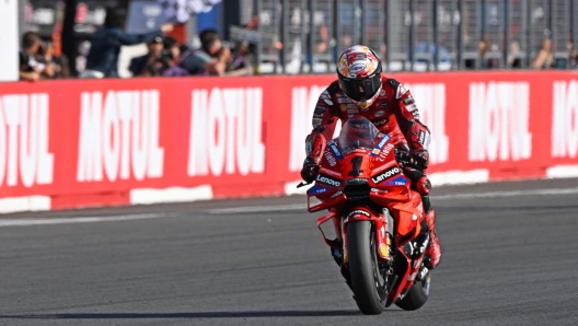 Ducati Lenovo Team rider Francesco Bagnaia of Italy receives the checkered flag to win the MotoGP class of MotoGP Japanese Grand Prix at the Mobility Resort Motegi in Motegi, Tochigi prefecture on October 6, 2024. (Photo by Toshifumi KITAMURA / AFP)