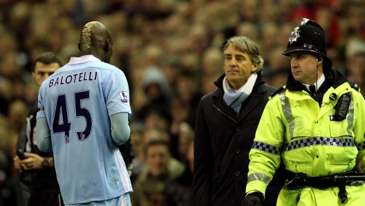 LIVERPOOL, ENGLAND - NOVEMBER 27: Manchester City Manager Roberto Mancini looks at Mario Balotelli as he heads for the dressing room after being sent off during the Barclays Premier League match between Liverpool and Manchester City at Anfield on November 27, 2011.