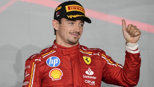 Ferrari driver Charles Leclerc of Monaco stands on the podium after finishing second at the Qatar Formula One Grand Prix at the Lusail International Circuit in Lusail, Qatar, Sunday, Dec. 1, 2024. (AP Photo/Darko Bandic)