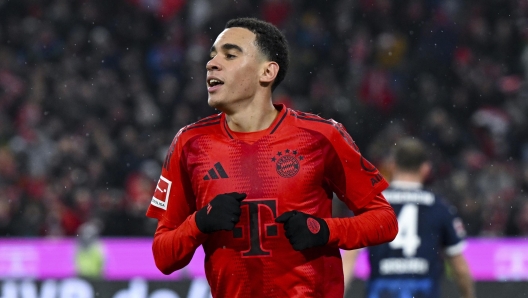 Munich's Jamal Musiala celebrates after scoring his side's fourth goal during the German Bundesliga soccer match between  FC Bayern Munich and 1. FC Heidenheim 1846 in Munich, Germany, Saturday, Dec. 7, 2024. (Sven Hoppe/dpa via AP)