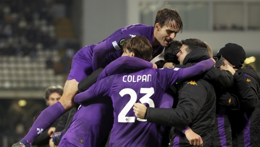 Fiorentina players celebrate after Rolando Mandragora scored their first goal during the Europa Conference League opening phase soccer match between Vitoria SC and Fiorentina at the D. Afonso Henriques stadium in Guimaraes, Portugal, Thursday, Dec. 19, 2024. (AP Photo/Luis Vieira)