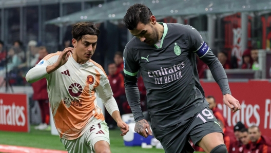 AC Milan's defender Theo Hernandez in action against AS Roma's forward Paulo Dybala during the Italian Serie A soccer match AC Milan vs AS Roma at Giuseppe Meazza Stadium in Milan, Italy, 29 December 2024. ANSA / ROBERTO BREGANI