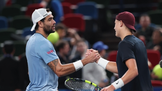 SHANGHAI, CHINA - OCTOBER 07: Holger Rune (R) of Denmark and Matteo Berrettini (L) of Italy shake hands at the net after the Men's Singles second round match on Day 8 of 2024 Shanghai Rolex Masters at Qi Zhong Tennis Centre on October 07, 2024 in Shanghai, China. (Photo by Lintao Zhang/Getty Images)