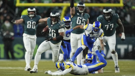 Philadelphia Eagles running back Saquon Barkley (26) runs for a touchdown during the first half of an NFL football NFC divisional playoff game against the Los Angeles Rams on Sunday, Jan. 19, 2025, in Philadelphia. (AP Photo/Matt Slocum)