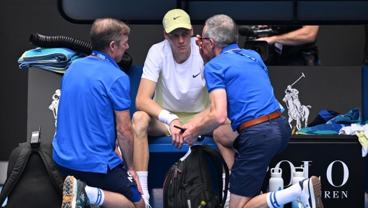 epa11837704 Jannik Sinner of Italy during a medical time out against Holger Rune of Denmark during their fourth round match during the Australian Open tennis tournament at Melbourne Park in Melbourne, Australia, 20 January 2025.  EPA/JAMES ROSS  AUSTRALIA AND NEW ZEALAND OUT