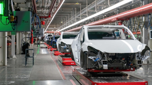 (FILES) Cars on the assembly line during a tour of the Tesla Giga Texas manufacturing facility ahead of the "Cyber Rodeo" grand opening party on April 7, 2022, in Austin, Texas. Tesla reported lower than expected profits on January 29, 2025, citing declining vehicle prices as a factor as it projected a return to volume growth in 2025. Elon Musk's electric car company reported fourth-quarter profits of $2.3 billion, which translated into 73 cents per share, four cents below analyst expectations. Revenues also lagged estimates. (Photo by SUZANNE CORDEIRO / AFP)