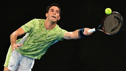 Italy?s Matteo Gigante hits a return against France's Ugo Humbert during their men's singles match on day one of the Australian Open tennis tournament in Melbourne on January 12, 2025. (Photo by Yuichi YAMAZAKI / AFP) / -- IMAGE RESTRICTED TO EDITORIAL USE - STRICTLY NO COMMERCIAL USE --