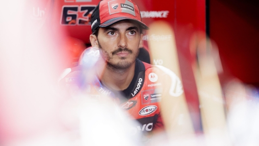 Francesco Bagnaia looking at his monitor in the pit garage.