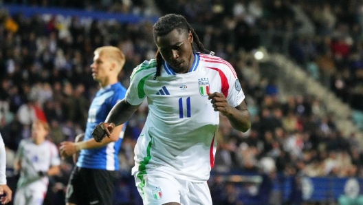 Moise Kean receiving medical attention on the field.