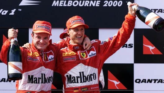 Rubens Barrichello e Michael Schumacher festeggiano il loro primo podio insieme in Ferrari. Afp