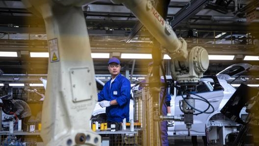 Operai al lavoro in una fabbrica della Byd a Xi’1an. Epa