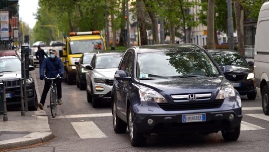 Una strada di Milano nuovamente  affollata di automobili. Ansa