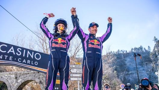 Isabelle Galmiche alza le braccia al cielo assieme a Sebastien Loeb dopo la vittoria del Rally di Montecarlo. Foto: Wrc