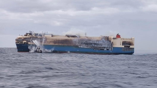 epa09775508 An undated handout photo made available by the Portuguese Navy (Marinha Portuguesa) shows smoke billowing from the burning 'Felicity Ace' ship, seen from the Portuguese Navy NRP Setubal offshore patrol vessel, southeast of the Azores in the Atlantic, Portugal (issued 21 February 2022). According to a statement released by the Felicity Ace Incident Information Centre, a fire broke out on the MOL operated Panama-flagged car carrier 'Felicity Ace' some 90 nautical miles southwest of the Azores in the Atlantic on 16 February, while on his way from Germany to the USA. All 22 crew members were safely evacuated from the ship and taken ashore. According to MOL Ship Management, two large tugs with firefighting equipment from Gibraltar were arranged to support the vessel, as well as a salvage craft with firefighting equipment from Rotterdam set to arrive between 23 to 24 February.  EPA/PORTUGUESE NAVY HANDOUT -- MANDATORY CREDIT -- HANDOUT EDITORIAL USE ONLY/NO SALES