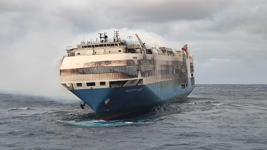 CORRECTS CREDIT TO PORTUGUESE NAVY INSTEAD OF AIR FORCE  In this undated photo provided by the Portuguese Navy, smoke billows from the burning Felicity Ace car transport ship as seen from the Portuguese Navy NPR Setubal ship southeast of the mid-Atlantic Portuguese Azores Islands. The ship's crew were taken by helicopter to Faial island on the archipelago, about 170 kilometers (100 miles) away on Wednesday, Feb. 16, 2022. There were no reported injuries. (Portuguese Navy via AP)