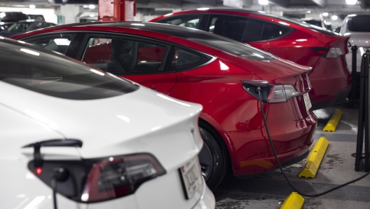 epa09747683 Tesla vehicles at a charging display station at Westfield Mall in Bethesda, Maryland, USA, 11 February 2022. The California-based company is recalling nearly 579,000 US vehicles over its 'boombox function' which may impeded pedestrians' ability to hear a required warning sound that the car is approaching.  EPA/JIM LO SCALZO