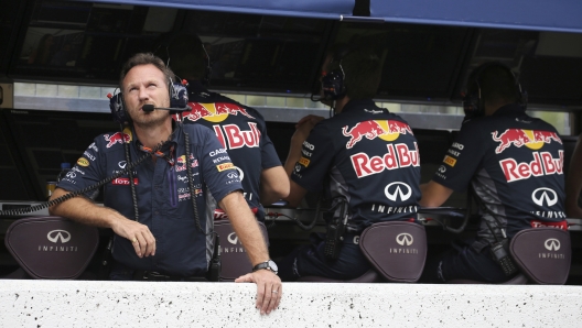 FILE - Red Bull Racing Team principal Christian Horner looks up during the qualifying session for the Japanese Formula One Grand Prix at the Suzuka Circuit in Suzuka, central Japan, Sept. 26, 2015. The Red Bull Formula One team has secured a new title sponsorship worth around $500 million with technology firm Oracle, placing it among the most lucrative commercial deals in sports. The five-year deal is a lift to the team ahead of the season beginning next month when Max Verstappen will be looking to defend his world title in a new Oracle Red Bull Racing car that was also revealed on Wednesday Feb. 9, 2022. (Yuriko Nakao/Pool via AP, file)