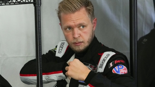 FILE - Kevin Magnussen, of Denmark, adjusts his driving suit after taking a turn driving on the track during a practice session for the Rolex 24 hour race at Daytona International Speedway in Daytona Beach, Fla., in this Friday, Jan. 29, 2021, file photo. Magnussen had not won a race in eight years when he lost his seat in Formula One and needed to find a new series. The Danish driver settled on racing a sports car in the United States for Chip Ganassi because Ganassi is committed to winning races. (AP Photo/John Raoux, File)