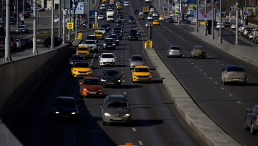 Cars, including a Russian-made Lada (2 bottom-top), move on a street in Moscow on March 10, 2022. (Photo by AFP)