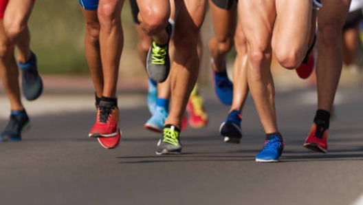 Marathon running race, people feet on city roa