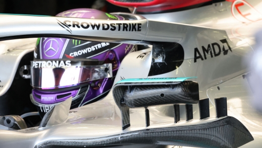 Mercedes' British driver Lewis Hamilton sits in his car during the third day of Formula One (F1) pre-season testing at the Bahrain International Circuit in the city of Sakhir on March 12, 2022. (Photo by Giuseppe CACACE / AFP)