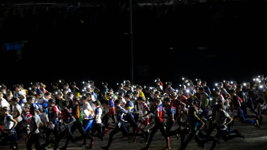 Participants take the start of the Arctic Circle Jukola orienteering run on August 21, 2021 in Rovaniemi, Finland. - According to the organisers, the Arctic Circle Jukola is the worlds largest orienteering relay race held from August 21 to 22, 2021 in Rovaniemi, in Finnish Lapland. The main competition started in the late evening of Saturday, August 21 and continued during the whole night until the late morning of Sunday, August 22. Contestants received a map and with the help of a compass they had to reach the punching points where their passage was electronically recorded. (Photo by Alessandro RAMPAZZO / AFP)