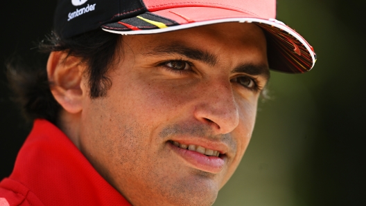 BAHRAIN, BAHRAIN - MARCH 17: Carlos Sainz of Spain and Ferrari looks on in the Paddock during previews ahead of the F1 Grand Prix of Bahrain at Bahrain International Circuit on March 17, 2022 in Bahrain, Bahrain. (Photo by Clive Mason/Getty Images)