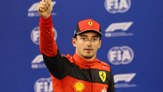 Ferrari's Monegasque driver Charles Leclerc reacts after taking pole position in  the qualifying session on the eve of the Bahrain Formula One Grand Prix at the Bahrain International Circuit in the city of Sakhir on March 19, 2022. (Photo by Giuseppe CACACE / POOL / AFP)