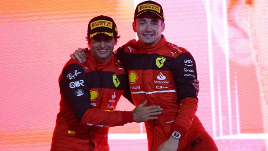 Winner Ferrari's Monegasque driver Charles Leclerc (L) and second place Ferrari's Spanish driver Carlos Sainz Jr celebrate on the podium after the Bahrain Formula One Grand Prix at the Bahrain International Circuit in the city of Sakhir on March 20, 2022. (Photo by Giuseppe CACACE / AFP)