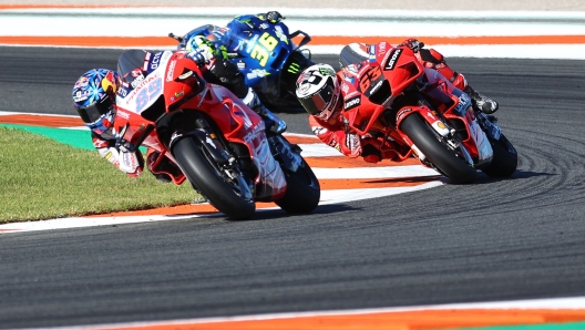 Ducati Pramac Racing Spanish rider Jorge Martin rides ahead Ducati Lenovo Team Italian rider Francesco Bagnaia and Suzuki Ecstar Spanish rider Joan Mir during the MotoGP race of the Valencia Grand Prix at the Ricardo Tormo racetrack in Cheste, on November 14, 2021. (Photo by JOSE JORDAN / AFP)