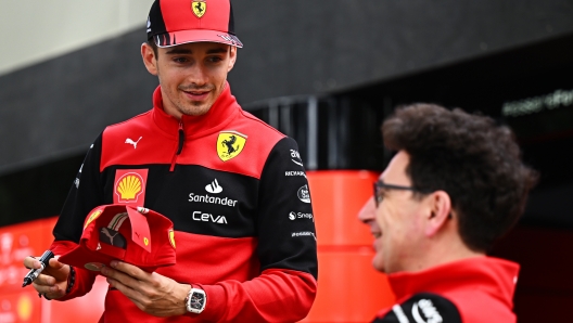 MELBOURNE, AUSTRALIA - APRIL 07: Charles Leclerc of Monaco and Ferrari talks with Scuderia Ferrari Team Principal Mattia Binotto during previews ahead of the F1 Grand Prix of Australia at Melbourne Grand Prix Circuit on April 07, 2022 in Melbourne, Australia. (Photo by Clive Mason/Getty Images)