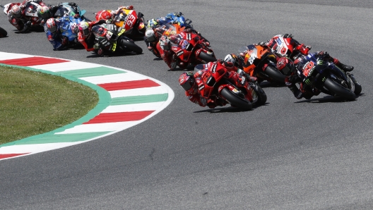 Ducati rider Francesco Bagnaia, of Italy, foreground left, and Yamaha rider Fabio Quartararo, of France, lead the pack during the Motogp Grand Prix of Italy at the Mugello circuit, in Scarperia, Italy, Sunday, May 30, 2021. (AP Photo/Antonio Calanni)