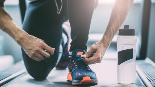 Portrait of a man tying shoelaces