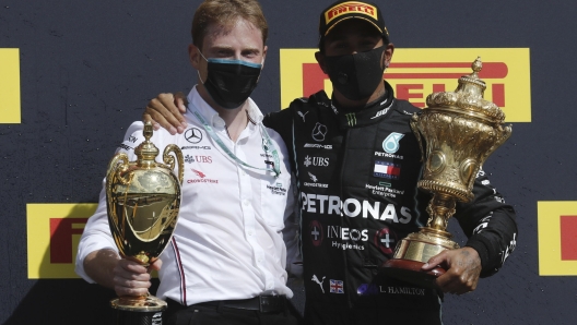 epa08580736 Digital Mock-Up Design Engineer Gilles Pironi (L) and British Formula One driver Lewis Hamilton of Mercedes-AMG Petronas (R) hold the trophies after wining the 2020 Formula One Grand Prix of Great Britain at the Silverstone Circuit, in Northamptonshire, Britain, 2 August 2020.  EPA/Frank Augstein / Pool