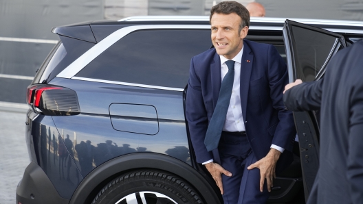 French President and centrist candidate for reelection Emmanuel Macron arrives to visit the Siemens Gamesa wind turbines factory in Le Havre, western France, Thursday, April 14, 2022. Facing a tougher-than expected fight for reelection, French President Emmanuel Macron has hit the campaign trail at last. (AP Photo/Michel Euler, Pool)