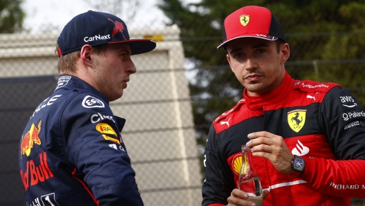 Ferrari's Monegasque driver Charles Leclerc (R) talks to Red Bull Racing's Dutch driver Max Verstappen after the sprint race at the Autodromo Internazionale Enzo e Dino Ferrari race track in Imola, Italy, on April 23, 2022,  ahead of the Formula One Emilia Romagna Grand Prix. (Photo by GUGLIELMO MANGIAPANE / POOL / AFP)