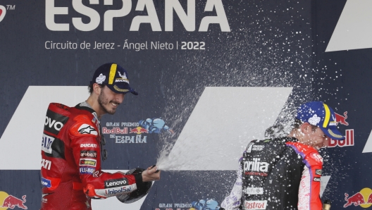 epa09920594 Italian rider Francesco Bagnaia (Ducati Lenovo Team) (L) celebrates on the podium with third-placed Aleix Espargaro (Aprilia RS-GP) after winning the MotoGP race within Spain's Motorcycling Gran Prix at 'Angel Nieto' racetrack in Jerez de la Frontera, Cadiz, Andalusia, southern Spain, 01 May 2022.  EPA/JOSE MANUEL VIDAL