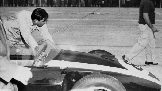 Jack Brabham of Australia pushes his Cooper-Climax racer to the finish line after he ran out of gas on the last lap of the race, Dec. 12, 1959 at Sebring, Fla. Brabham was holding the lead in the final lap. He collapsed on the track from exhaustion after crossing the finish line. (AP Photo/Harold Valentine)