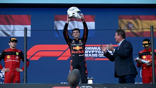 (L-R) Ferrari's Monegasque driver Charles Leclerc, Red Bull Racing's Dutch driver Max Verstappen, and Ferrari's Spanish driver Carlos Sainz celebrate on the podium after the Miami Formula One Grand Prix at the Miami International Autodrome in Miami Gardens, Florida, on May 8, 2022. (Photo by Brendan SMIALOWSKI / AFP)