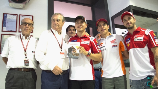 SCARPERIA, ITALY - JUNE 01:  (L-R) Carmelo Ezpeleta of Spain and Dorna CEO  and Dottor Claudio Marcello Costa of Italy and Jorge Lorenzo of Spain and Ducati Team and Marc Marquez of Spain and Repsol Honda Team and Andrea Dovizioso of Italy and Ducati Team pose during the presentation of the new book of Dottor Costa "L'eroe che e' in te" in media center during the MotoGp of Italy - Previews at Mugello Circuit on June 1, 2017 in Scarperia, Italy.  (Photo by Mirco Lazzari gp/Getty Images)