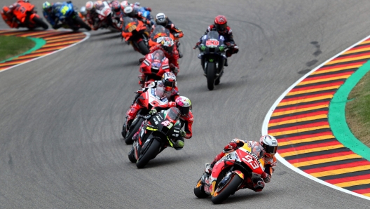 TOPSHOT - Honda Spanish rider Marc Marquez (Front) steers his motorbike during the German MotoGP Grand Prix at the Sachsenring racing circuit in Hohenstein-Ernstthal near Chemnitz, eastern Germany, on June 20, 2021. (Photo by Ronny HARTMANN / AFP)