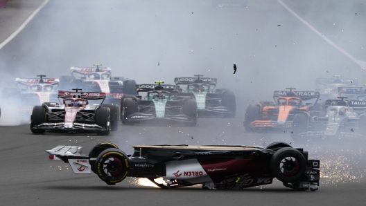 Alfa Romeo driver Guanyu Zhou of China crashes at the start of the British Formula One Grand Prix at the Silverstone circuit, in Silverstone, England, Sunday, July 3, 2022. (AP Photo/Frank Augstein)