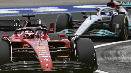 Ferrari driver Charles Leclerc of Monaco steers his car followed by Mercedes driver George Russell of Britain during the Hungarian Formula One Grand Prix at the Hungaroring racetrack in Mogyorod, near Budapest, Hungary, Sunday, July 31, 2022. (AP Photo/Anna Szilagyi)