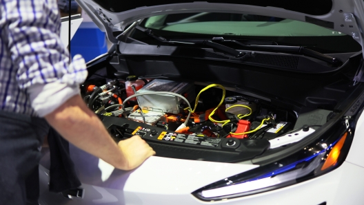 NEW YORK, NEW YORK - APRIL 15: People look at the engine of a Chevrolet Bolt EV at the New York International Auto Show at the Jacob K. Javits Convention Center on April 15, 2022 in New York City. The New York International Auto Show returned for the first time in two years after being cancelled amid the coronavirus (COVID-19) pandemic. The show, which runs from April 15-24, has vehicles from dozens of car companies, including new 2022 and 2023 models and will display concept cars along with the latest technological innovation in the automotive industry. A portion of the show will be dedicated to electric vehicles.   Michael M. Santiago/Getty Images/AFP == FOR NEWSPAPERS, INTERNET, TELCOS & TELEVISION USE ONLY ==