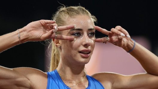 Gaia Sabbatini, of Italy, gestures after finishing the Women's 1500 meters during the athletics competition in the Olympic Stadium at the European Championships in Munich, Germany, Friday, Aug. 19, 2022. (AP Photo/Martin Meissner)