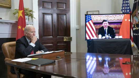 epa09584529 US President Joe Biden listens during a virtual summit with Chinese President Xi Jinping in the Roosevelt Room of the White House in Washington DC, USA, 15 November 2021.  EPA/SARAH SILBIGER / POOL